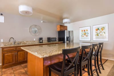 A kitchen area with granite countertops and appliances