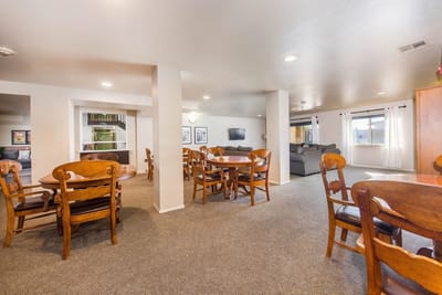 Bright common area with dining tables and seating
