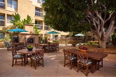 Outdoor seating area with tables and umbrellas