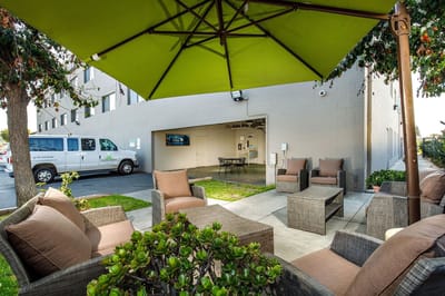 Outdoor seating area with van in background