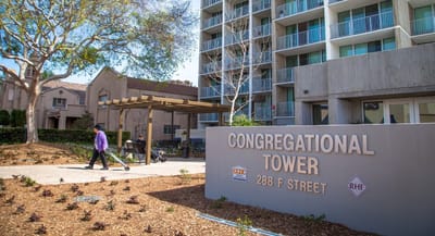 Exterior view of Congregational Tower with a resident walking