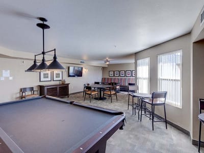 Interior view of a common area with seating and pool table