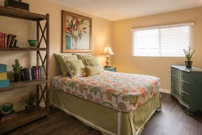 Cozy resident room with floral decor and furniture