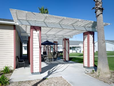 Outdoor shaded seating area with chairs and tables