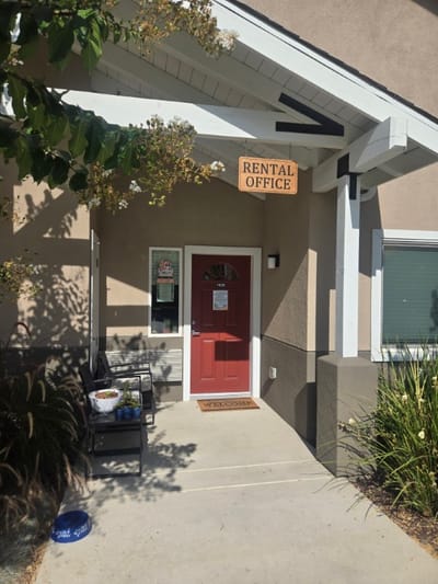 Facade of the rental office with a red door