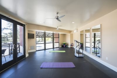 Interior view of a fitness room with exercise mats
