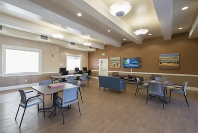 Common area with tables and seating in a bright interior