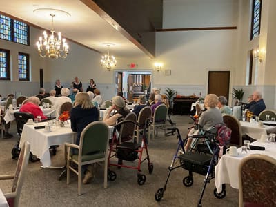 Residents attending an activity in a dining room