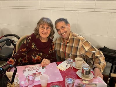 Two residents enjoying a meal together at a table