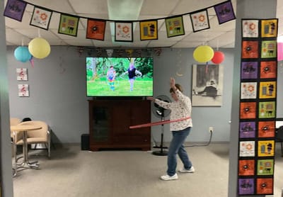 Resident enjoying a hula hoop activity in a common area