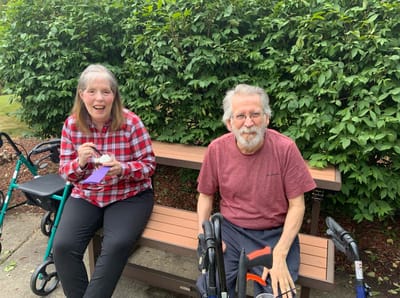 Residents enjoying ice cream outdoors on a bench