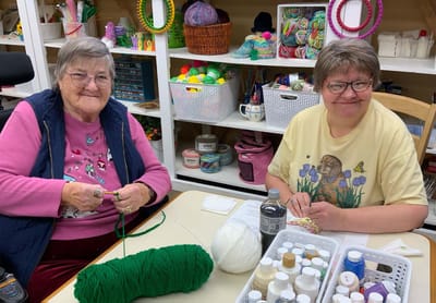 Two residents enjoying a craft activity together