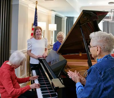 Residents enjoying a piano performance during an activity