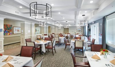Elegant dining room with white tablecloths and flower centerpieces