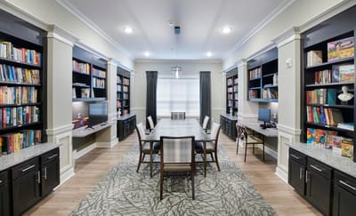 Interior common area with bookshelves and a table