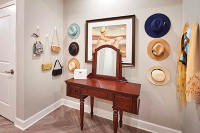 Stylish entryway with hats and artwork