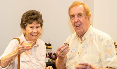 Two residents enjoying a social event with refreshments