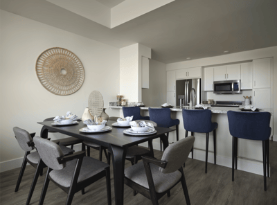 Modern dining area with set tableware and kitchen