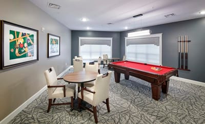 Bright common area with a pool table and seating