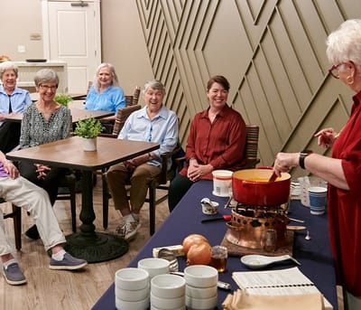 Residents participating in a cooking activity in a common area