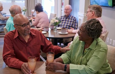 Residents enjoying drinks in a dining area