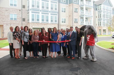 Ribbon cutting ceremony with staff and community members