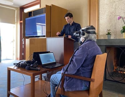 A resident engaging in virtual reality with staff supervision