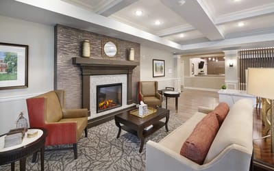 Common area with seating and fireplace in a senior living facility