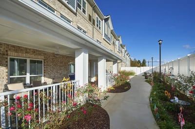 Pathway through landscaped outdoor space at a senior living community