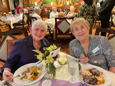 Two residents enjoying dinner in the dining room