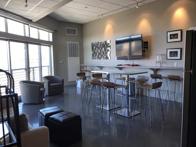 Bright common area with modern seating and bar