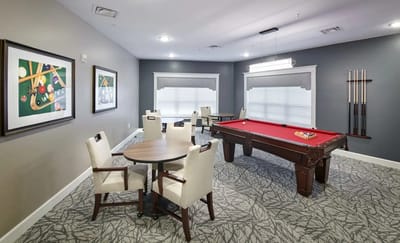 Interior game room with pool table and seating area