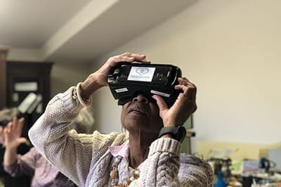 A resident using virtual reality glasses indoors