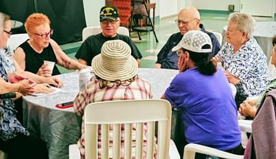 Residents enjoying a group activity around a table