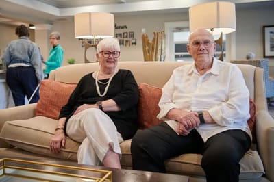 Two residents sitting together in a cozy common area