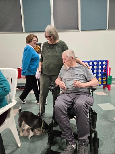 Residents engaging with a pet in a common area