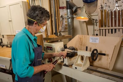 Resident engaged in woodworking activity in a workshop