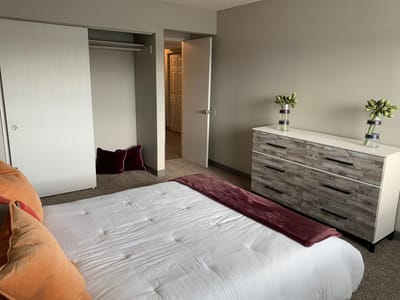 Cozy, well-furnished private room with a bed and dresser