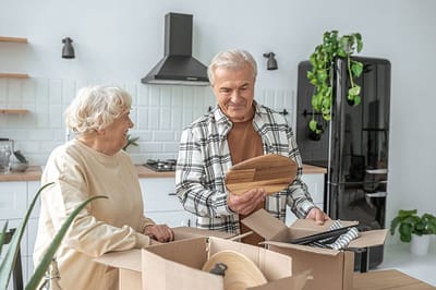 Couple unpacking boxes in a bright kitchen