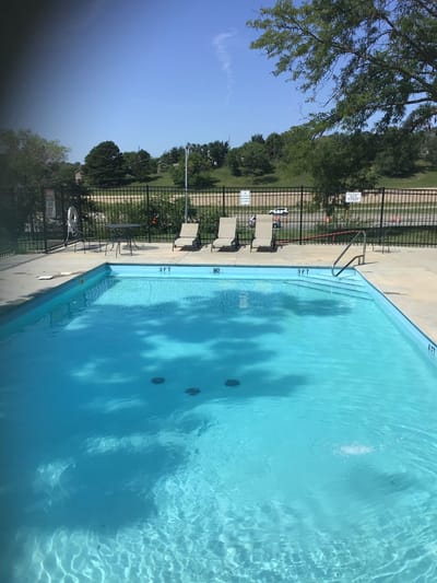 A serene outdoor swimming pool with lounge chairs