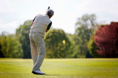 Person golfing on a sunny outdoor course