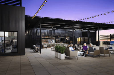 Residents enjoying an outdoor lounge area with comfortable seating