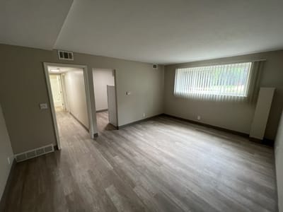 Empty interior room with light-colored walls and flooring
