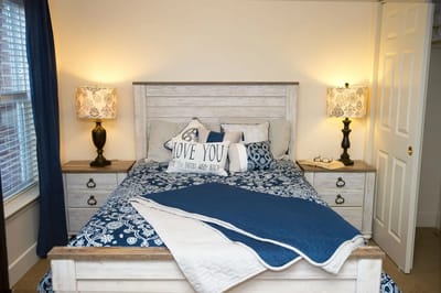 A well-decorated bedroom with soft lighting and blue accents