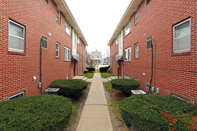 Pathway between residential buildings with landscaping