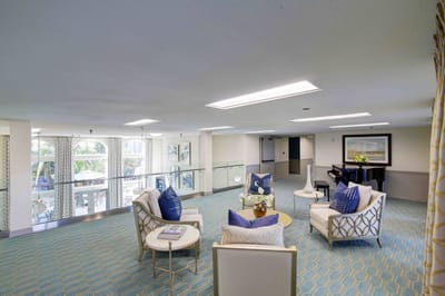 Bright common area with comfortable seating and piano