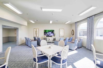 Common area with seating and television in a bright room