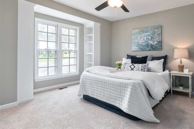 Cozy, well-decorated resident room with a bed and windows