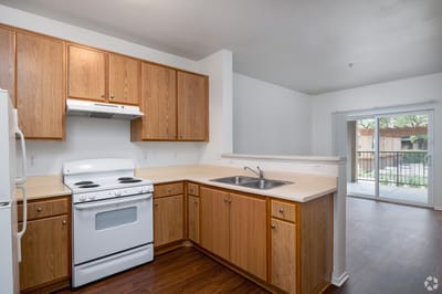 Bright kitchen area with wooden cabinets