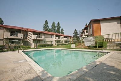 Outdoor swimming pool area with apartment buildings